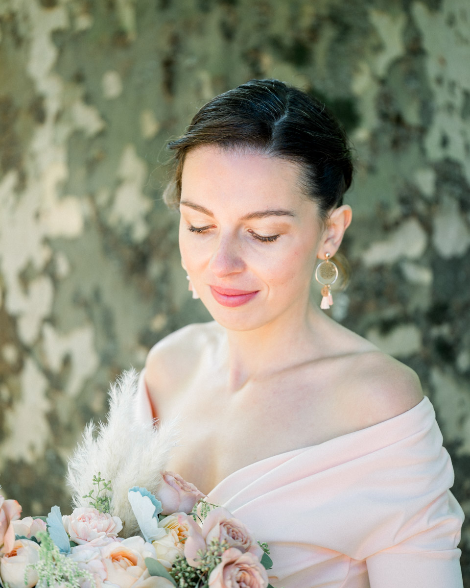Portrait of the young woman with lowered eyes against plane tree bark