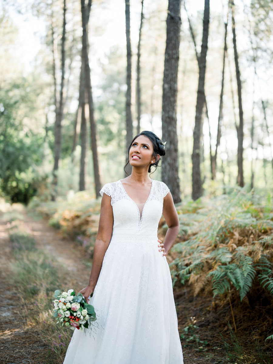 Portrait of the smiling bride on a fern-lined path
