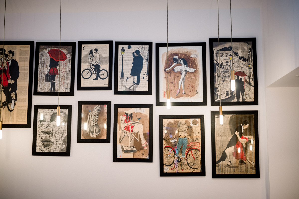 Wall of frames with retro illustrations in Le Résinier restaurant, Le Barp