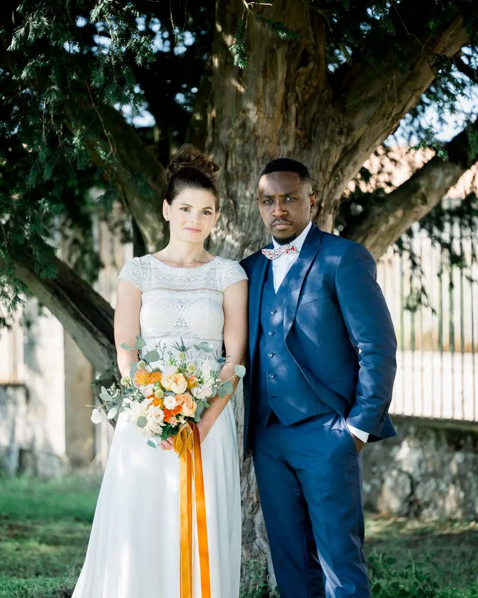 Claire and Mohamed posing beneath a large tree at Château Courtade-Dubuc