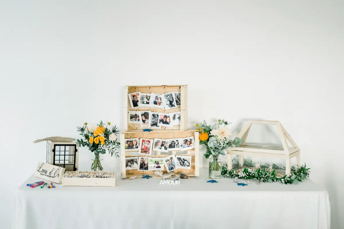 Table with a photo display, orange flowers and a wood and glass card box