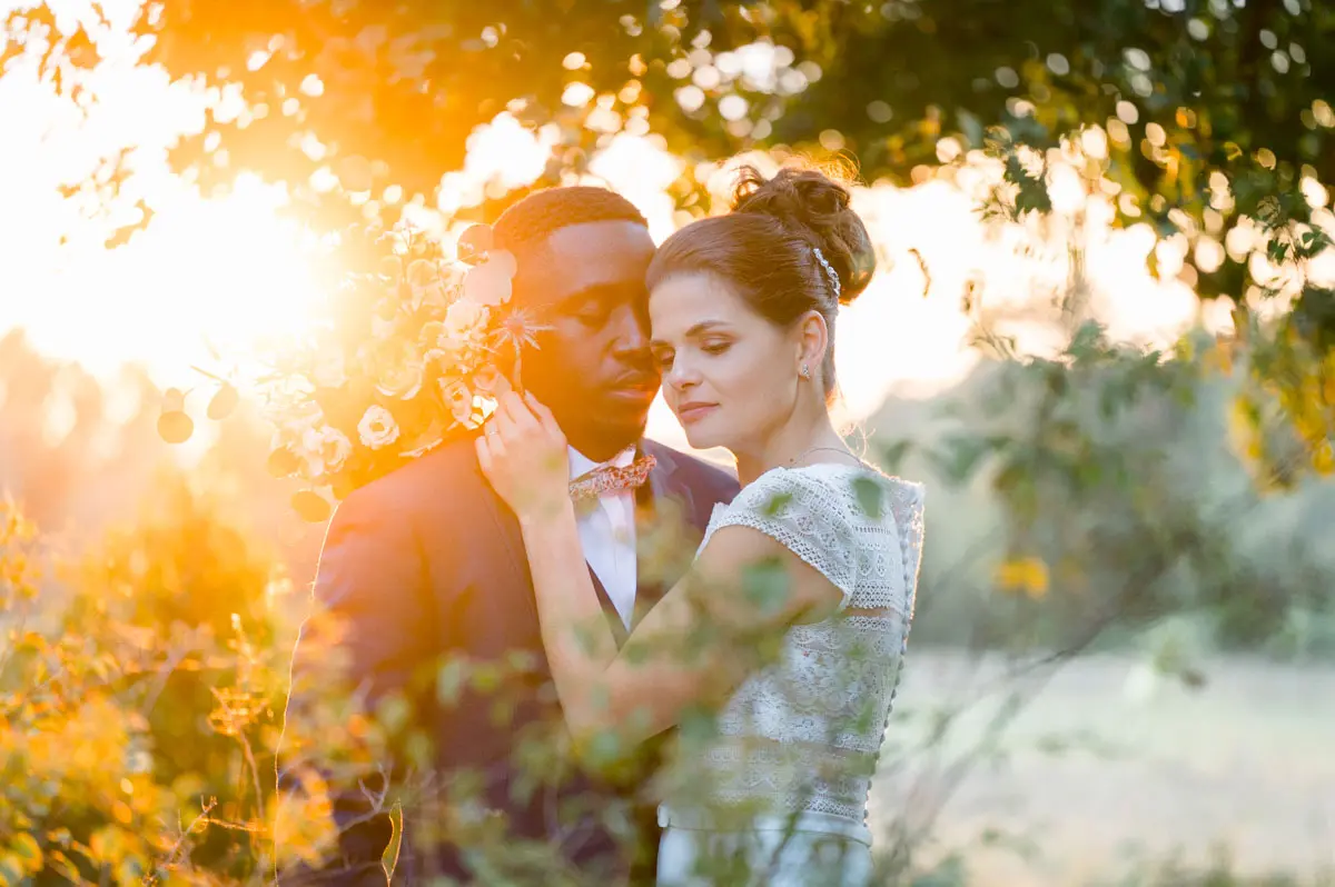 The couple embracing, backlit by the golden sunset