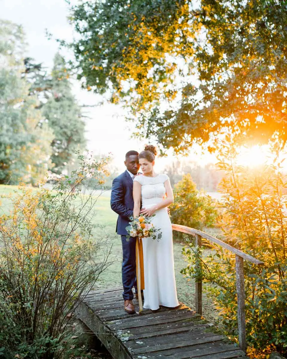 The couple on the wooden footbridge at sunset