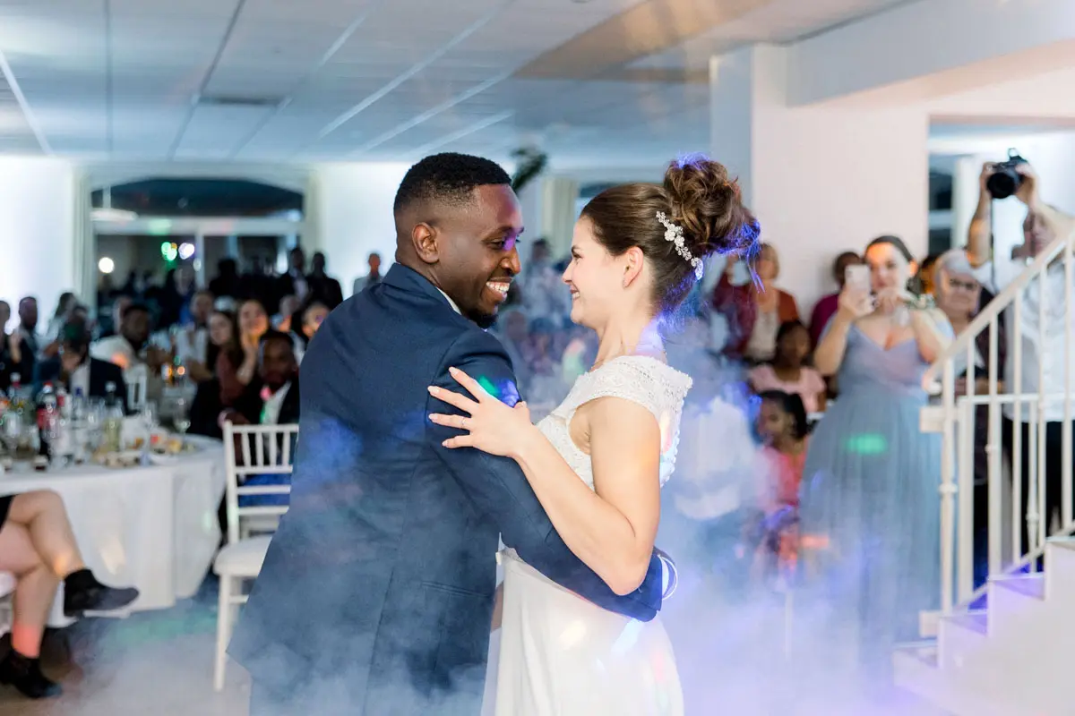 The couple's first dance in a haze of smoke, surrounded by guests