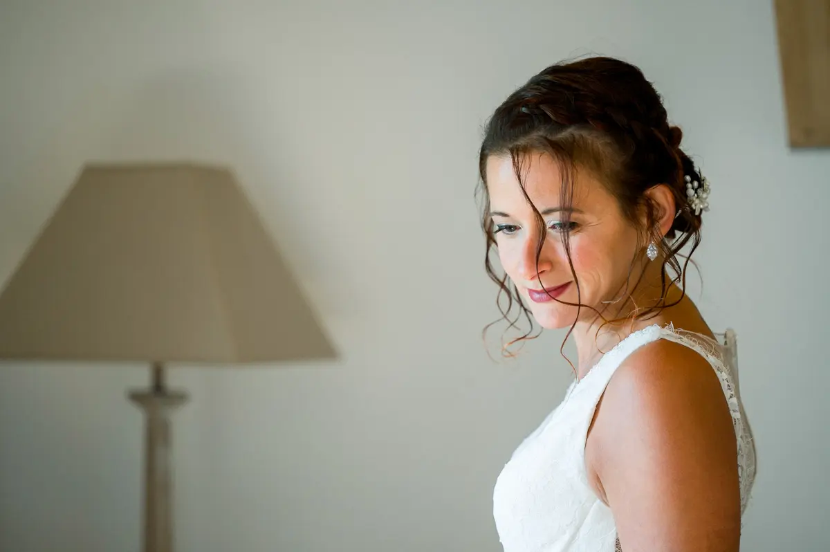Profile of the smiling bride in a thin-strapped gown
