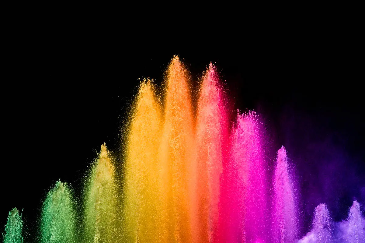 Water jets lit yellow, orange and pink during the fountain show