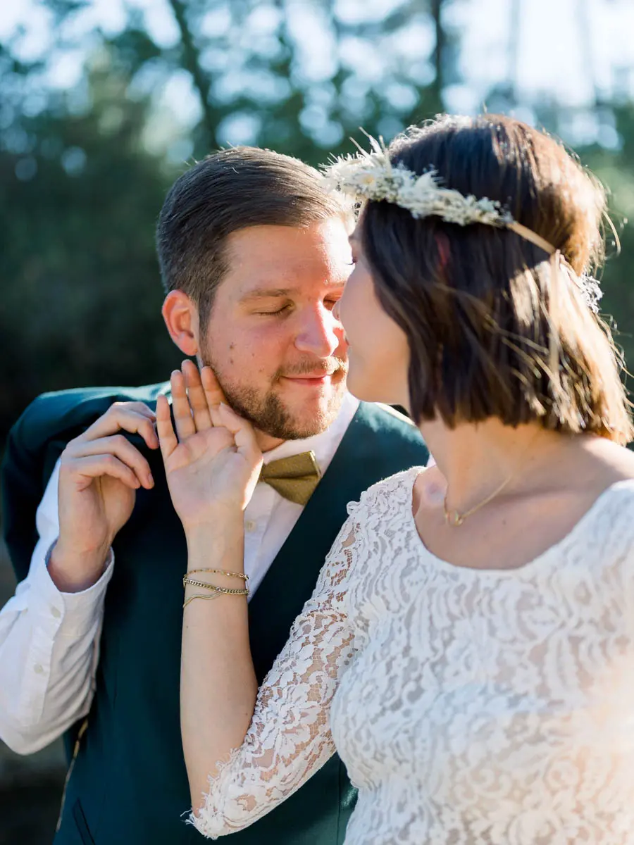 The bride touching the groom's beard as they lean forehead to forehead