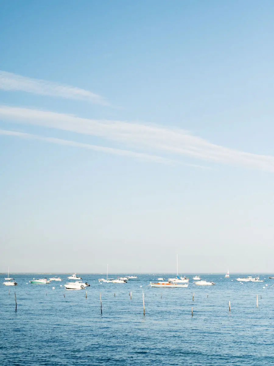 Boats moored on Arcachon Bay beneath a light sky