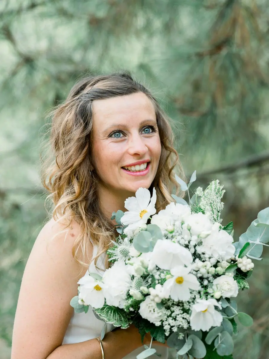 Smiling portrait of a mother with her bouquet of white flowers