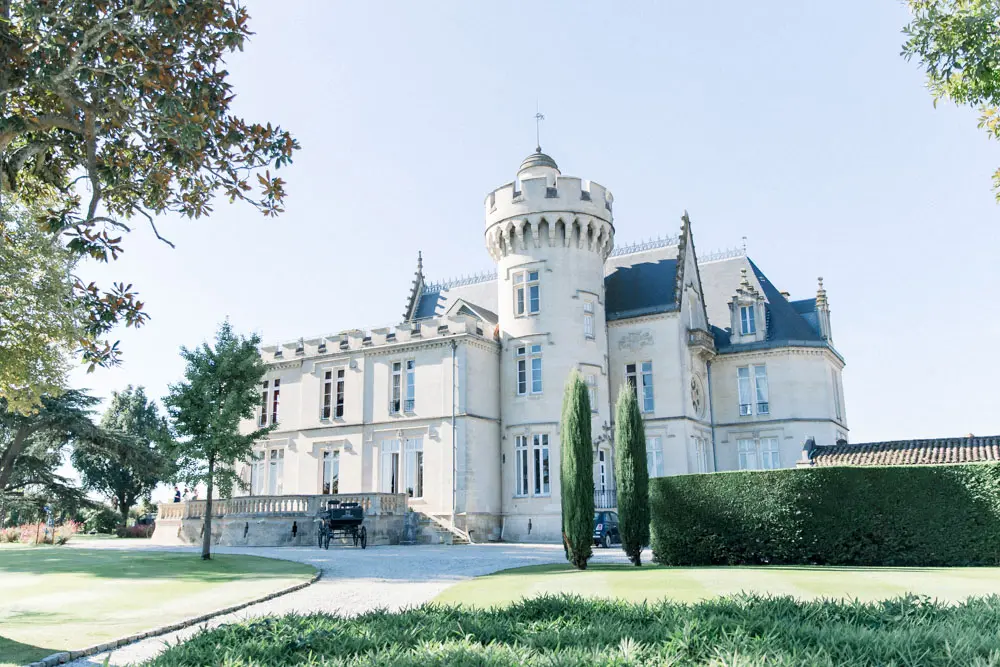 Château Pape Clément and its turrets under a clear sky in Pessac