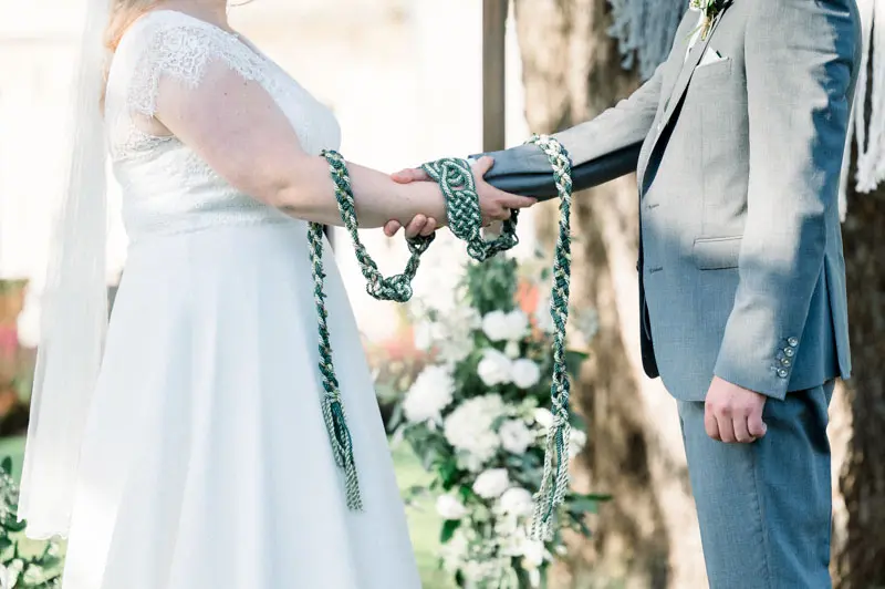 The couple's hands bound with a cord in the Irish handfasting ritual
