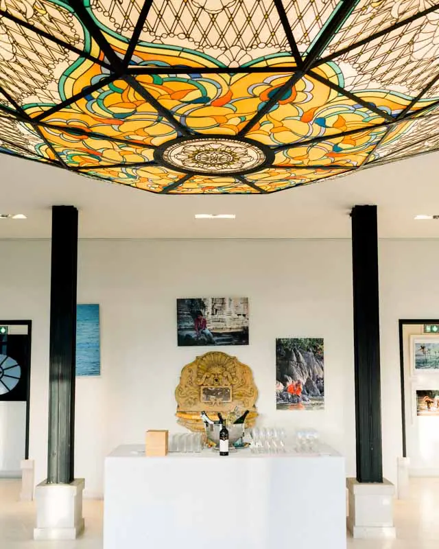 Drinks reception room beneath a coloured glass ceiling at Château Pape Clément