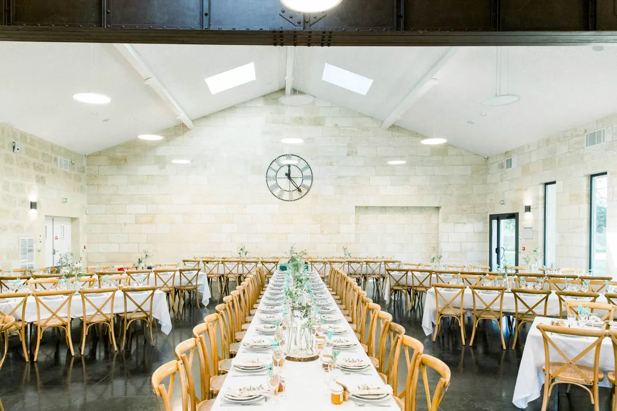 Reception hall at Domaine de Conseillant set with long tables, Cubzac-les-Ponts