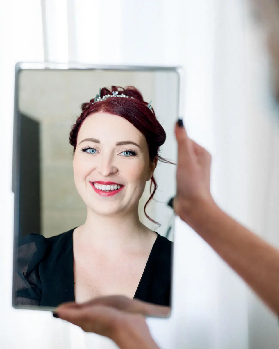 Tiffa's reflection in a hand mirror during her hair and make-up