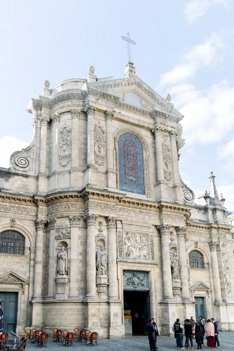 Baroque façade of Notre-Dame church in Bordeaux under a blue sky