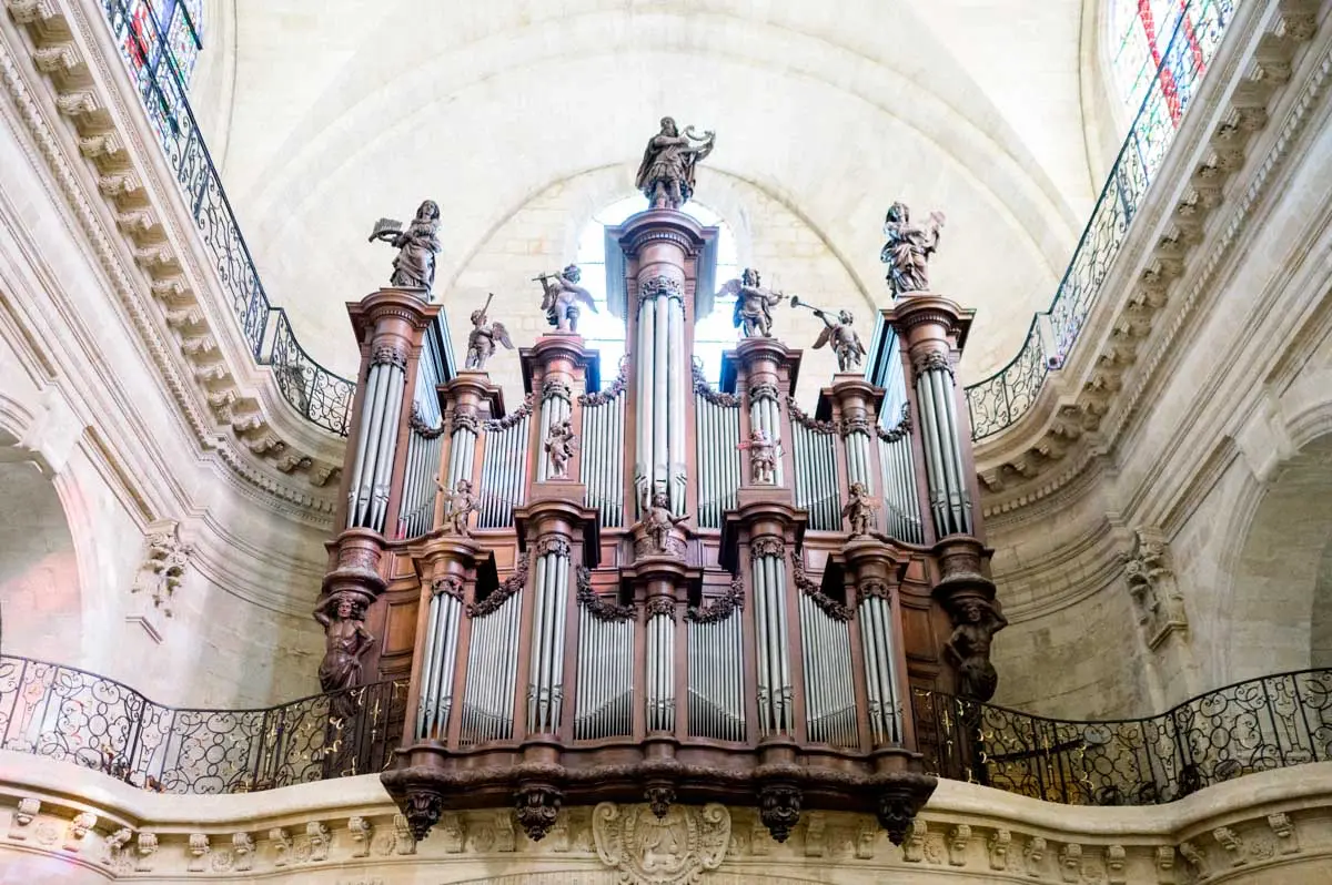 Carved organ case beneath the vaults of Notre-Dame church in Bordeaux