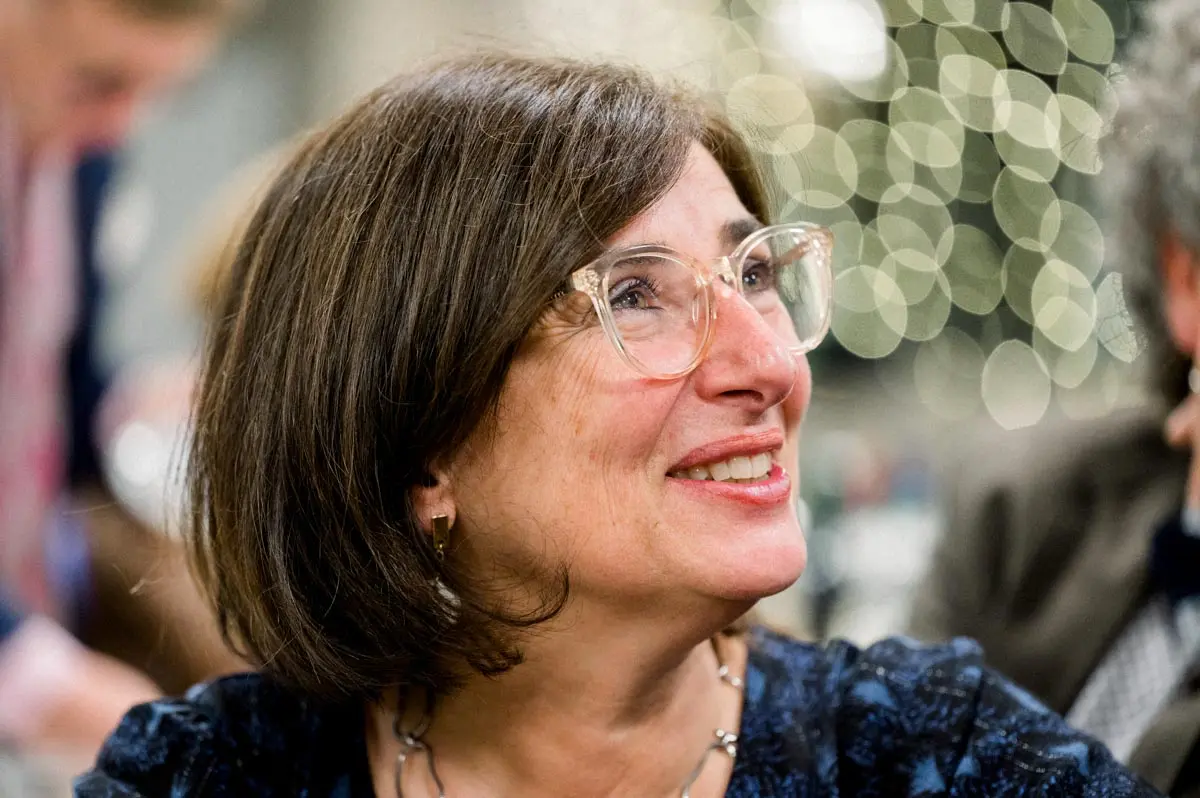A guest in glasses smiling with emotion during the speeches