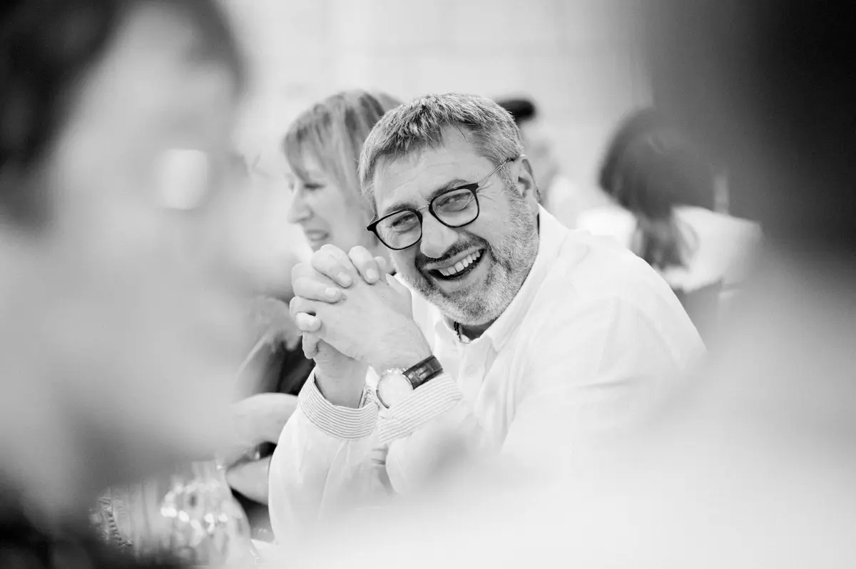 A guest in fits of laughter during the dinner speeches, in black and white