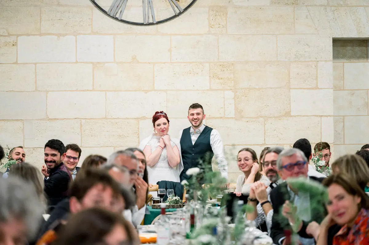 The couple standing among the tables during dinner at Domaine de Conseillant