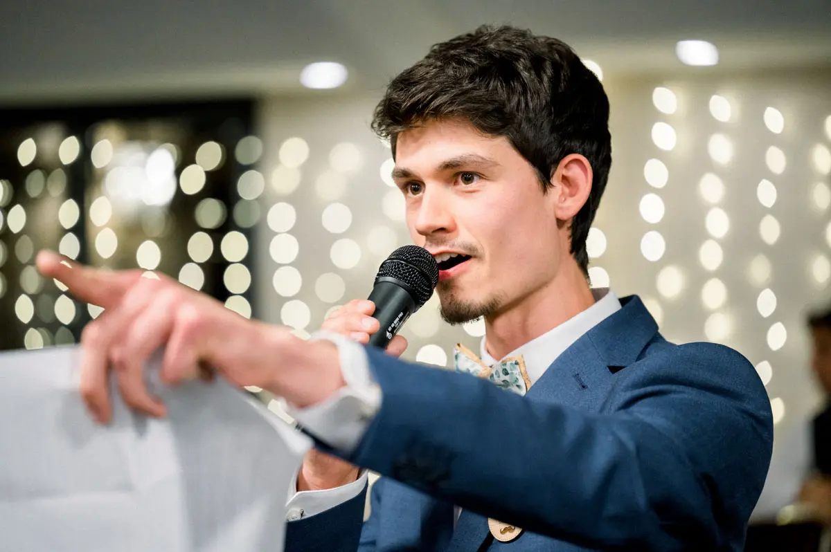 A guest pointing as he gives his speech into the microphone