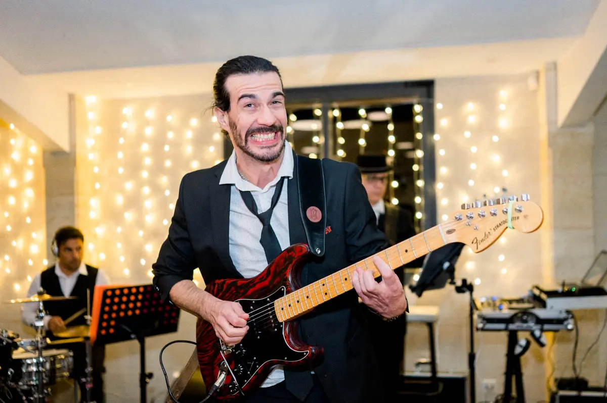 PopCorn Factory Orchestra guitarist in full swing on stage
