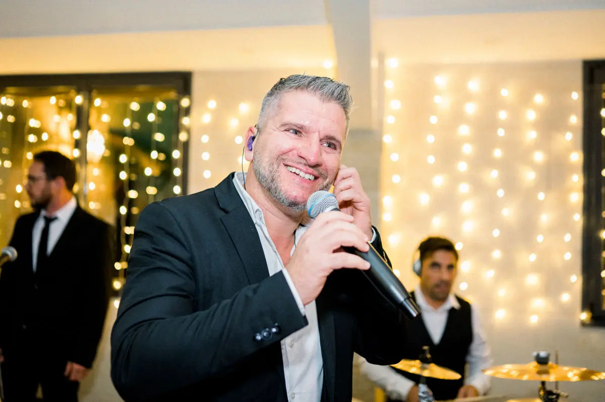 The PopCorn Factory Orchestra singer at the microphone during the party