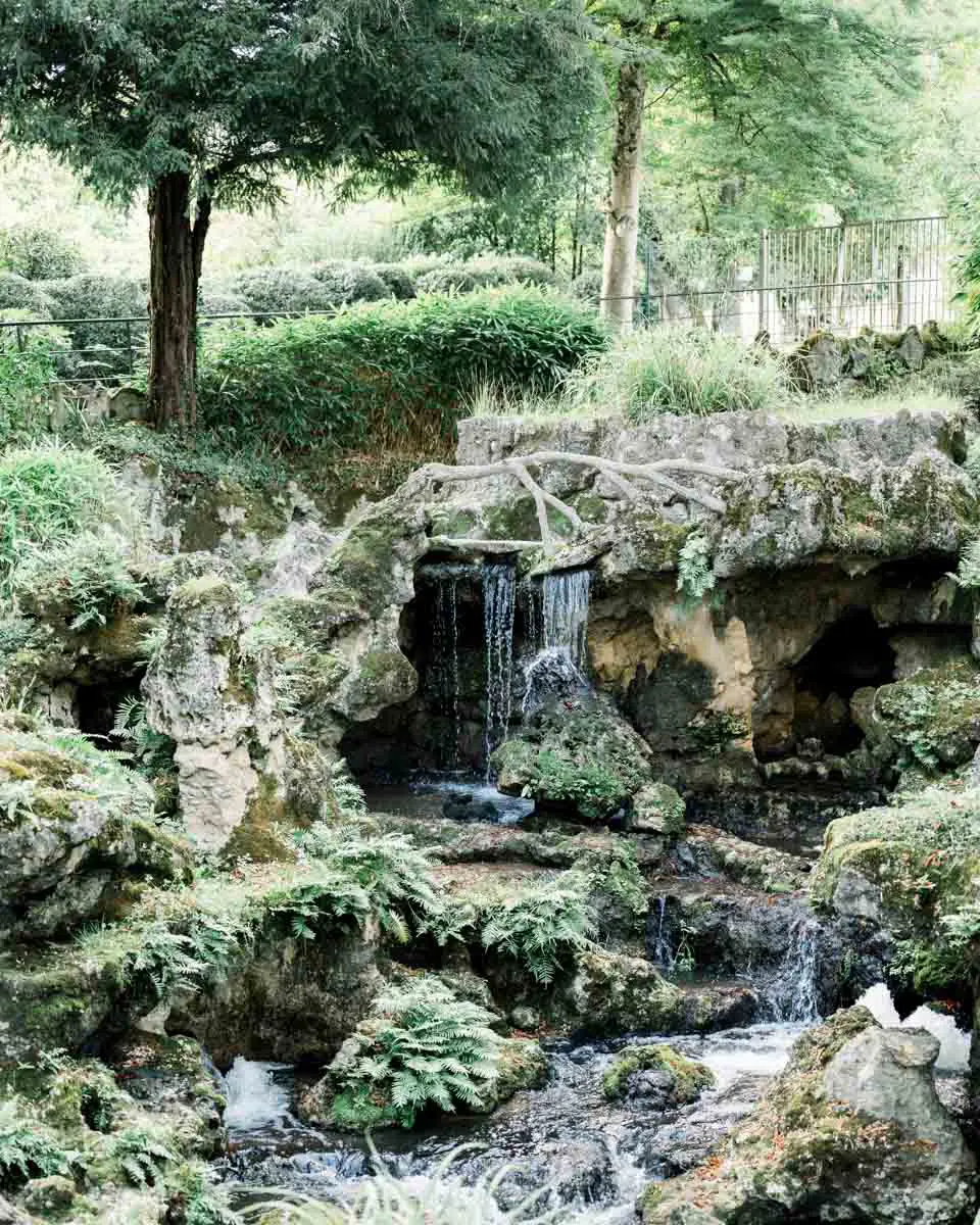 Waterfall and rockwork amid the greenery of Parc Majolan
