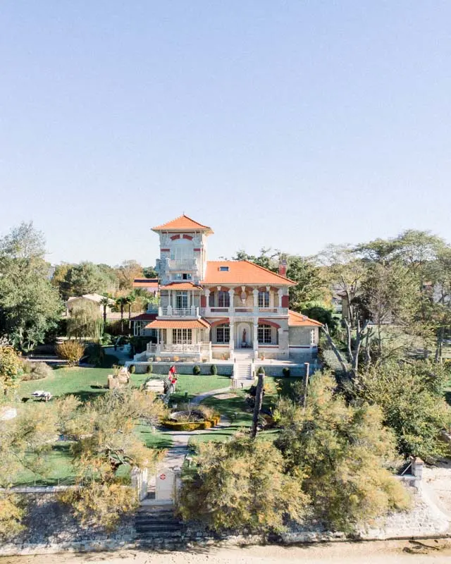 Villa La Tosca and its garden overlooking Arcachon Bay under a clear blue sky