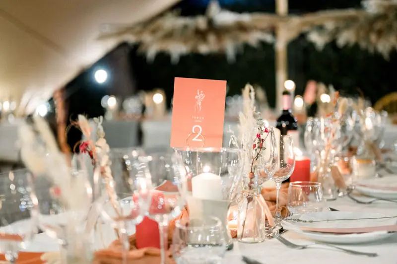 Wedding table with candles, glasses, dried flowers and table number two