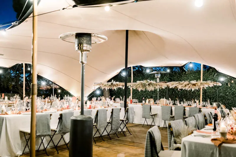Stretch tent and long tables set for the wedding dinner