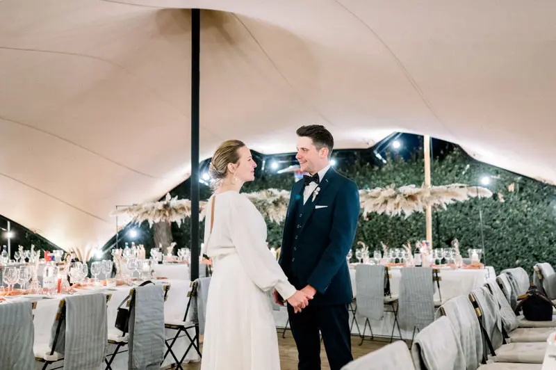 Bride and groom discovering the reception tent before dinner