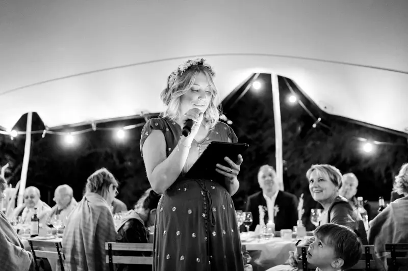 Guest giving a speech in front of the dinner tables, black and white