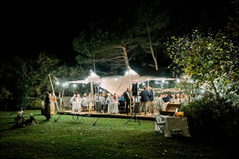 The lit reception tent in the villa's garden at nightfall