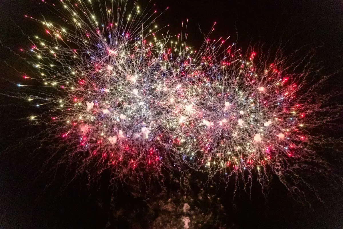 Red and gold fireworks finale above Domaine de Cordet