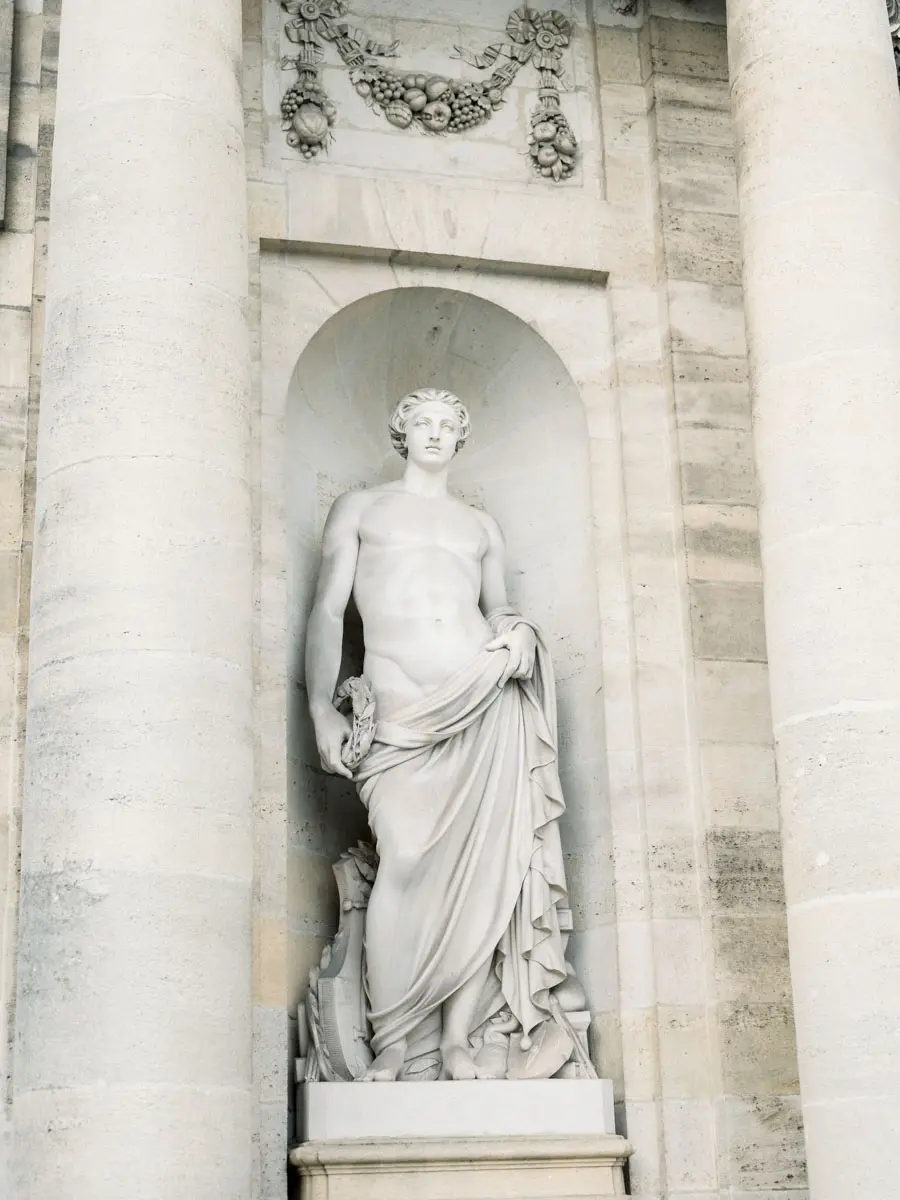 Stone statue in a niche on the façade of Bordeaux town hall