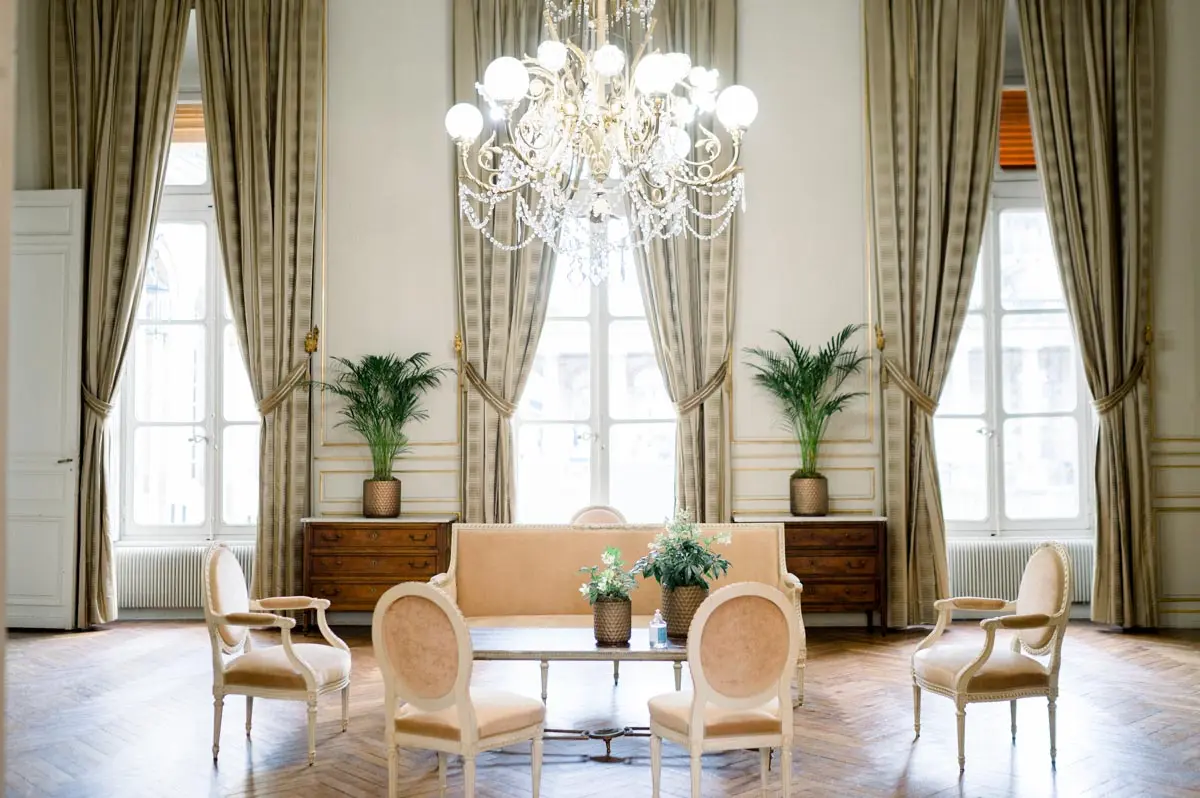 Formal reception room at Bordeaux town hall with armchairs and tall curtains