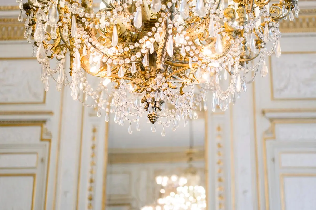 Gilded chandelier in the wedding hall seen from below