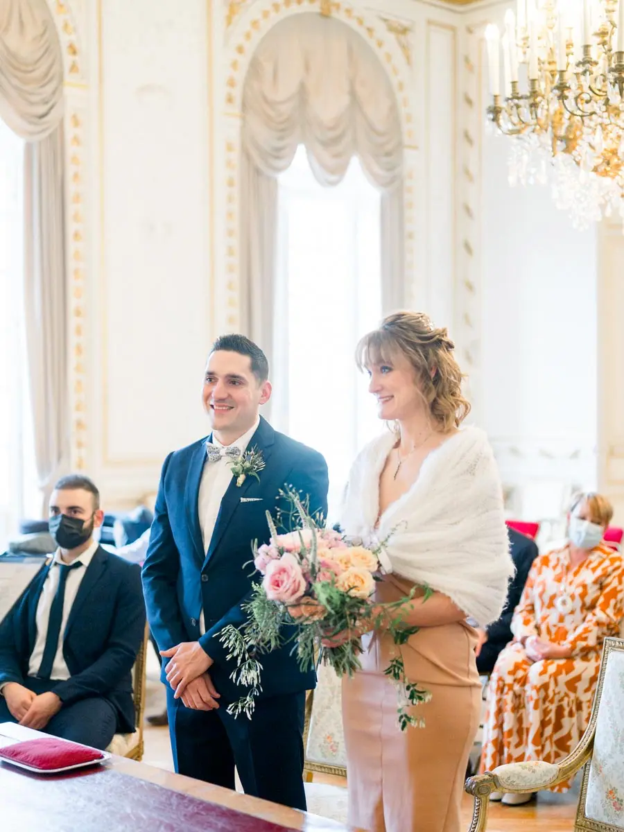 The couple standing during the civil ceremony at Bordeaux town hall