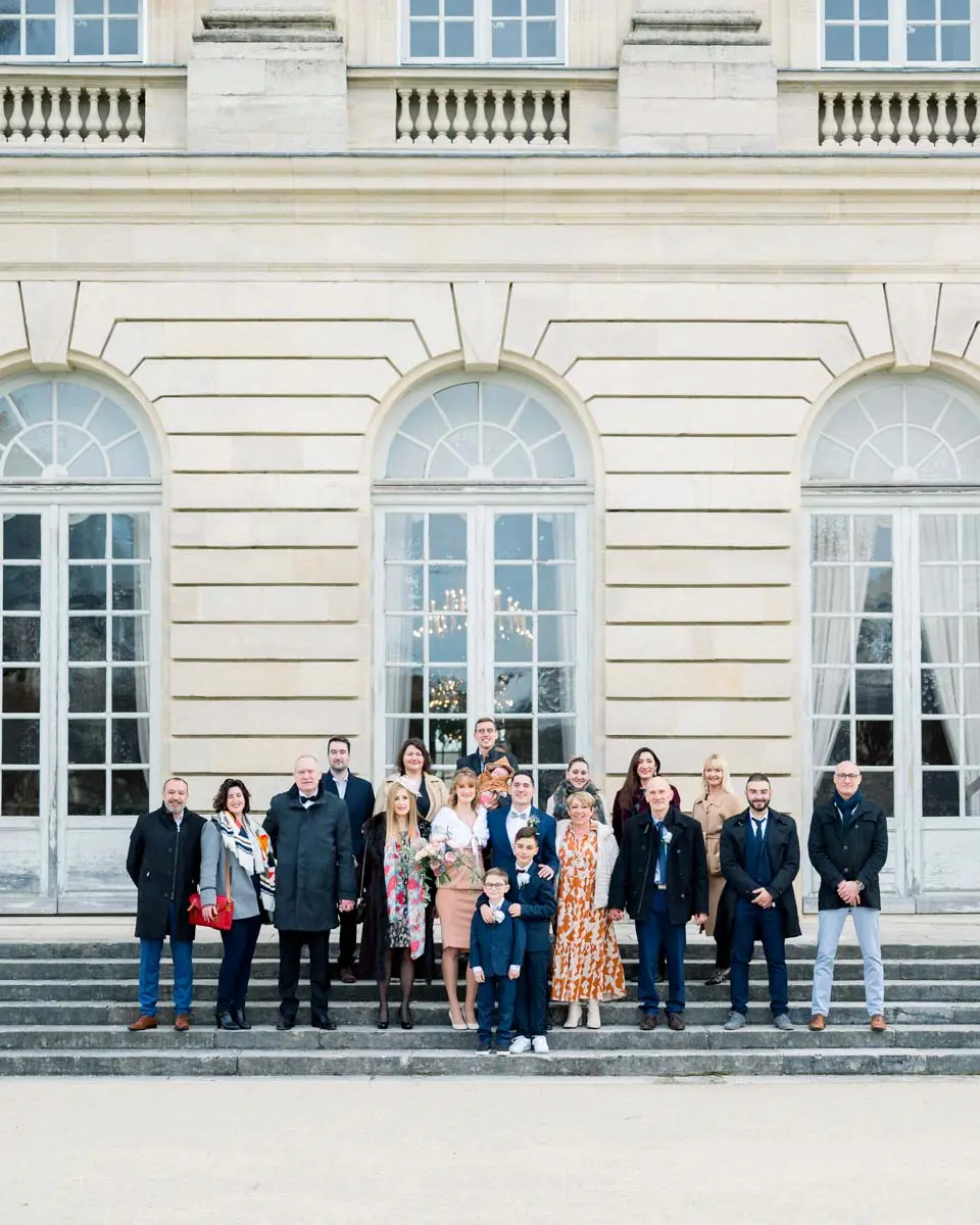 Group photo of the couple and guests in front of Bordeaux town hall