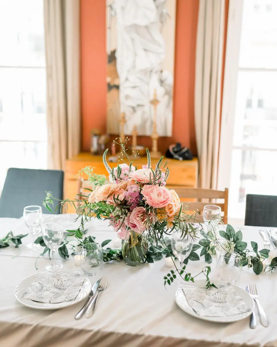 Lunch table laid with pastel flowers and eucalyptus foliage