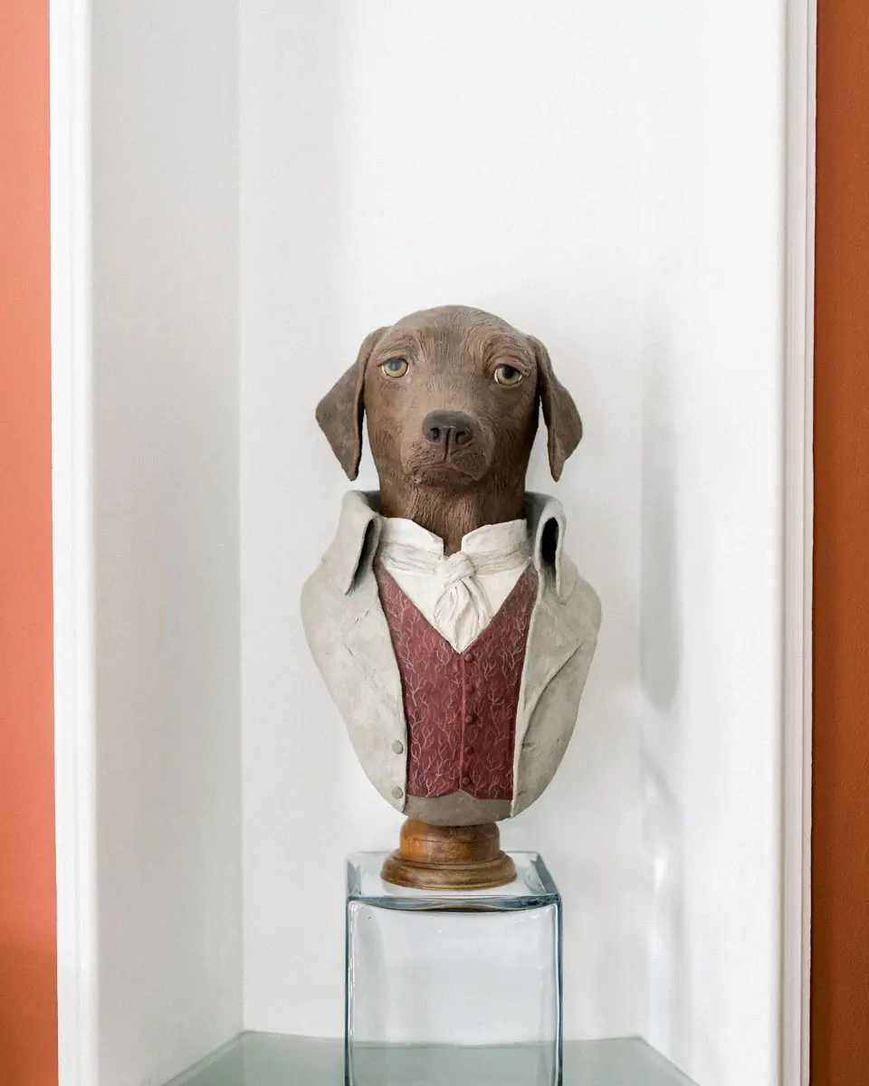 Bust of a dog in a waistcoat on a plinth, part of the reception venue's décor