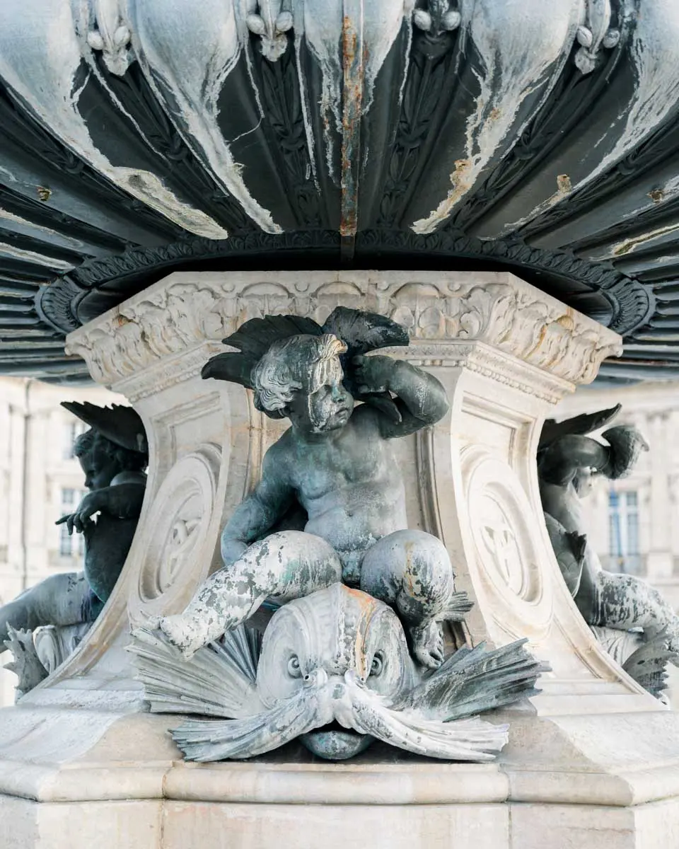 Sculpted detail of a bronze fountain basin in Bordeaux