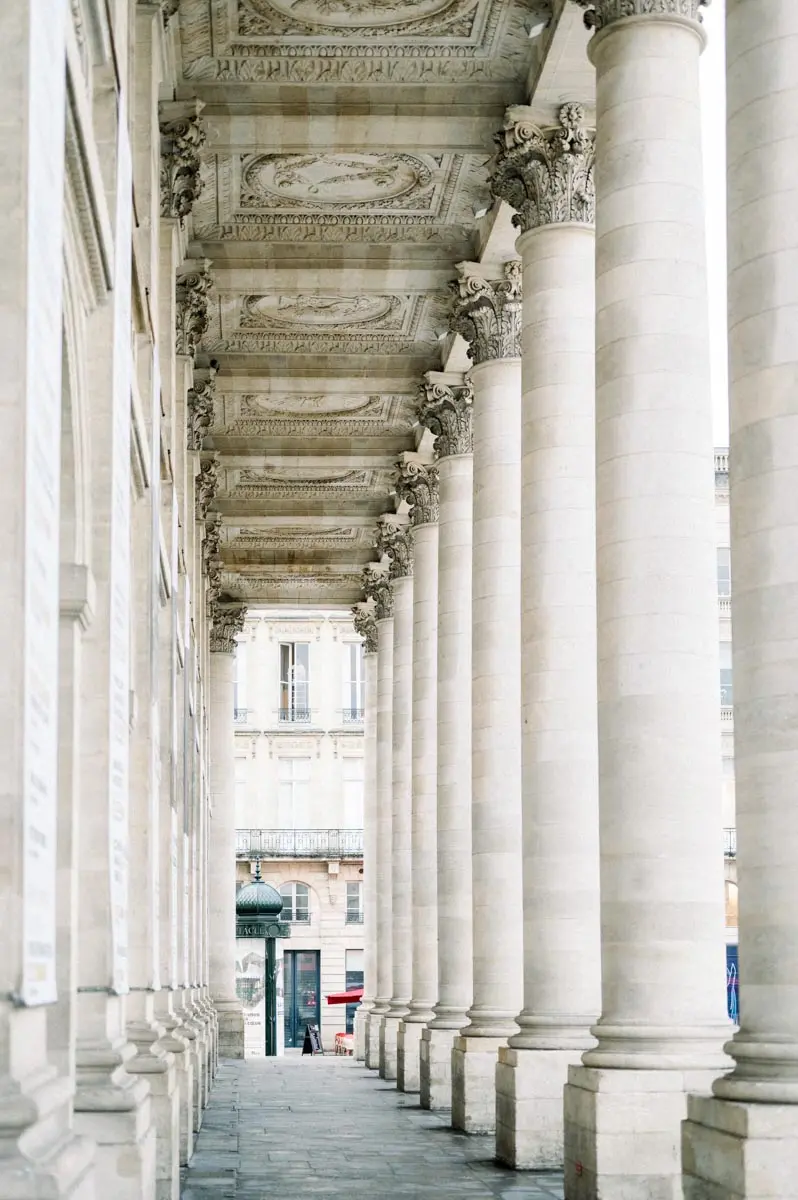 Stone colonnade of a grand classical building in central Bordeaux