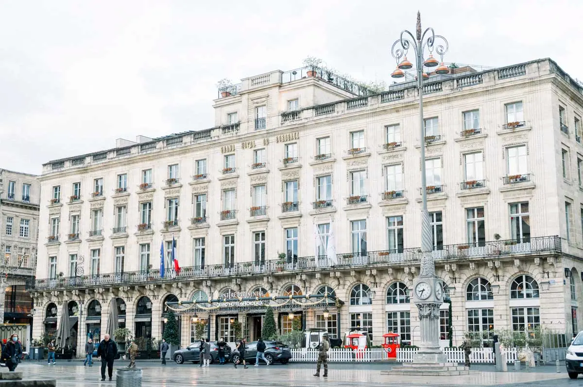Facade of the Grand Hôtel de Bordeaux under a grey autumn sky