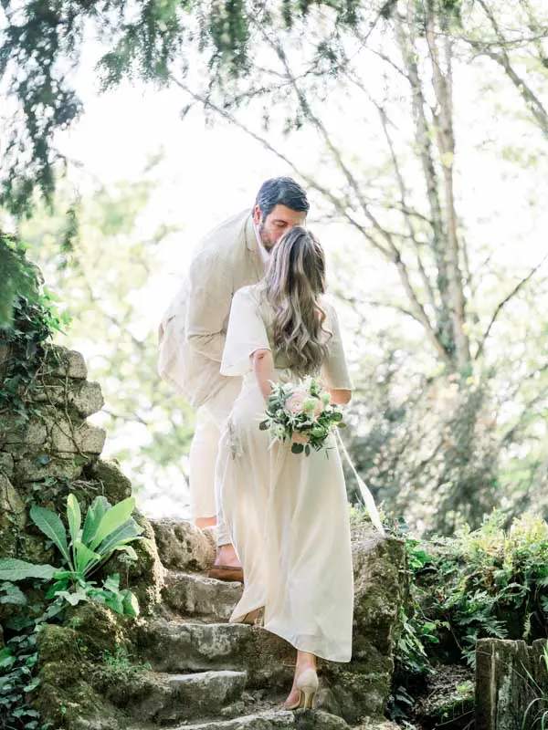 Julien kissing Simone's forehead on the stone steps