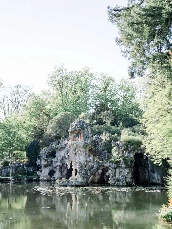 The grottoes and rocks of Parc Majolan beside the pond