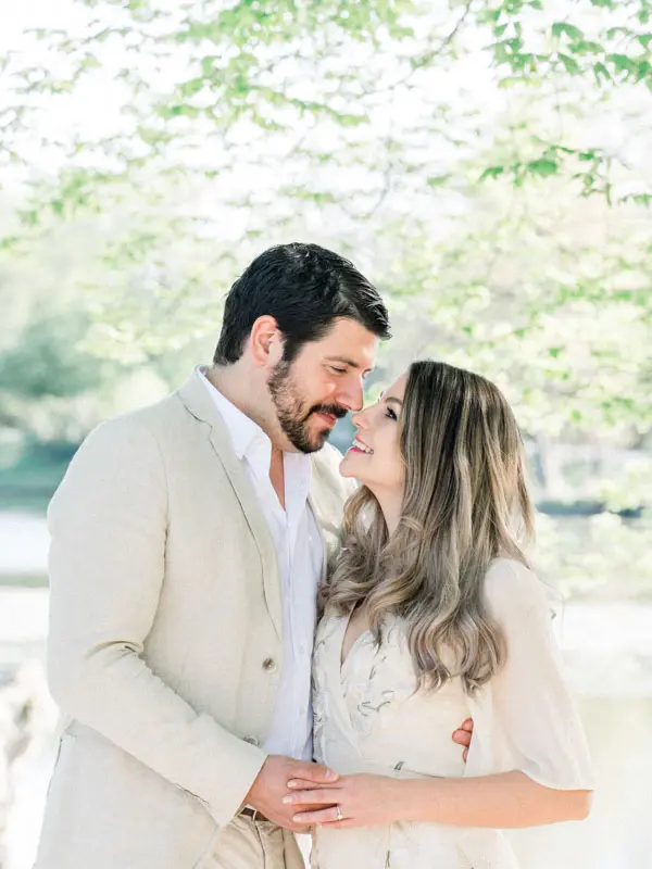 The couple forehead to forehead by the water, gentle and tender