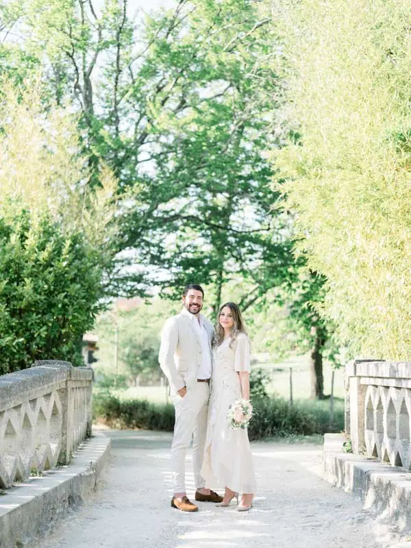 The couple on a bridge with stone balustrades in the park
