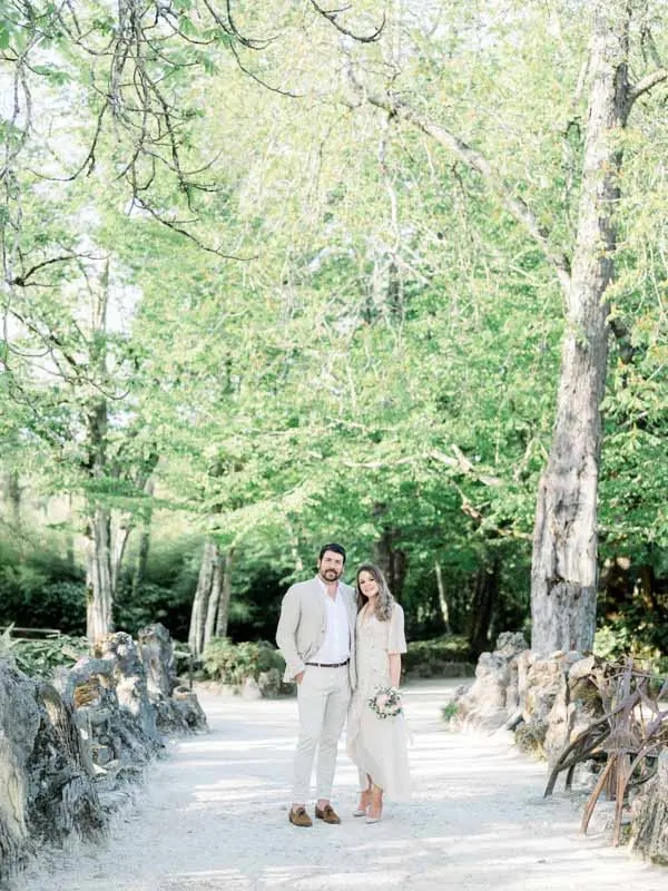 The couple on a wide tree-lined avenue in Parc Majolan