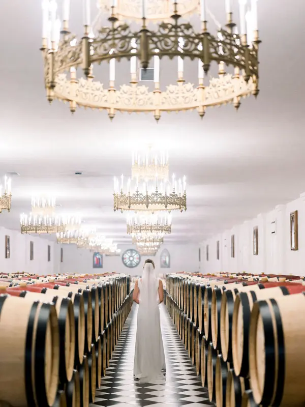 Barrel cellar beneath chandeliers at Château Pape Clément